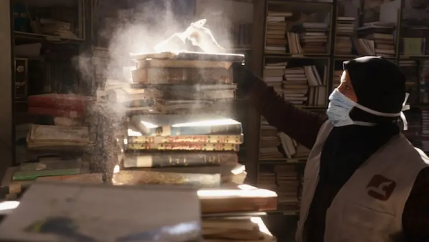 Armed with paintbrushes, volunteers try to preserve rare books at Gaza City's Omari library