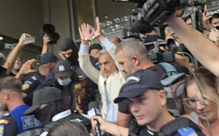 VIDEO: Călin Georgescu ridică mâinile încătușate la ieșirea de la DIICOT pentru a fi dus în arest